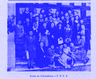 Group of women posing on steps in front of a building.
